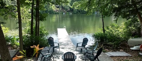 View of waterfront sitting area and seasonal floating dock
