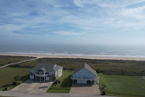 Rear view showing cart path to the beach on the left.