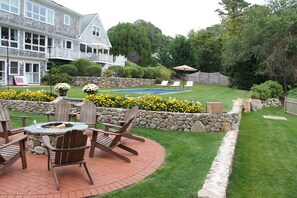 Fire pit, horseshoes pit and custom crafted rock walls with abundant landscapin
