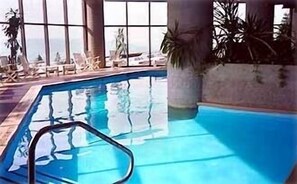 Heated Indoor Pool with waterfall next to sports center--first floor of building