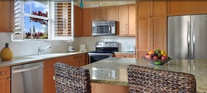 Granite counter tops in the gourmet kitchen with Stainless appliances.