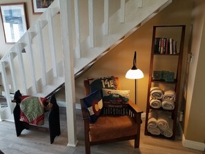 Reading chair, boot dryer behind chair.  Large towels for hot tub.  