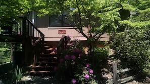 View of stairs up to deck from driveway