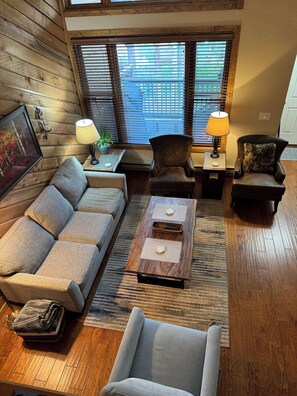Living room from the kitchen above.  Deck right outside