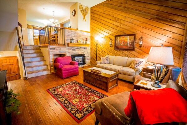 Living Room with Kitchen Located Up the Stairs