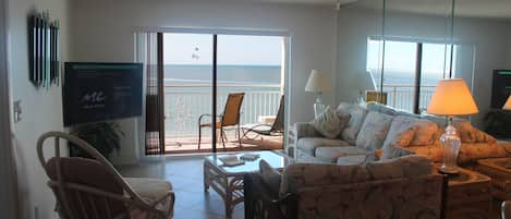 Living room and balcony, parasail ad flying by.