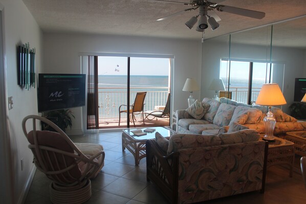 Living room and balcony, parasail ad flying by.