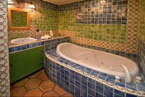 Colorful bathroom with large jacuzzi tub and shower.