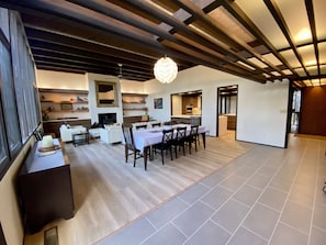 Great Room - dining for 10 guests and leather fireplace seating. 12’ ceiling.