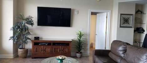 65" TELEVISION, LEATHER FURNITURE, TILE FLOORS