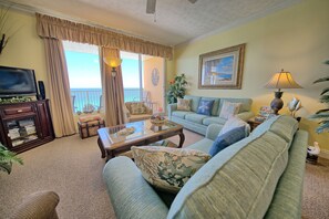 STEP OUT OUT OF THE LIVING AREA ONTO THE HUGE PATIO OVERLOOKING THE GULF .