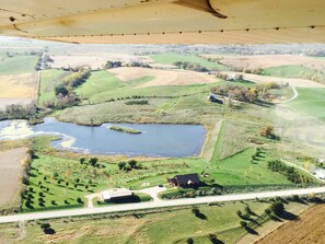 Buck Run Lodge sits above private pond shown along bottom of photo.