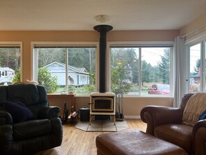 Wood-burning fireplace in living room, ocean and forest views. 