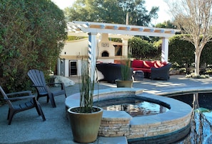 Jacuzzi and outdoor kitchen with TV