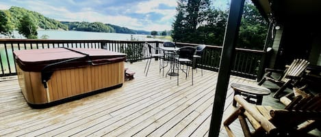 Large Deck with hot tub and sloping yard to water