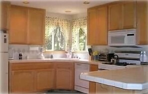 Large well-equiped kitchen with counter (not upgraded)  Flows to dining area