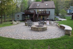 Huge Patio with fireplace, bar, bench, lots of chairs, Hot Tub and more!