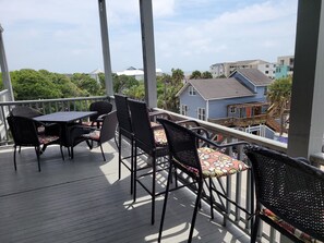 Porch with plenty of chairs.