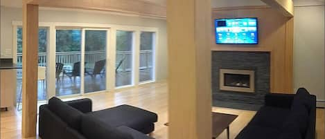 Living room with tv, wifi, gas fireplace and deck.