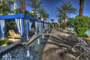 Close view of the cabanas and fountains at the master pool area