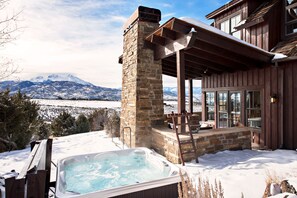 Hot tub off the deck, next to the cozy outdoor fireplace