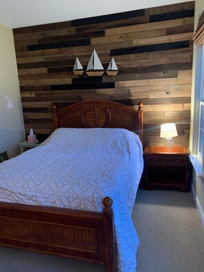 Beautiful master bedroom with two Adirondack chairs on porch 