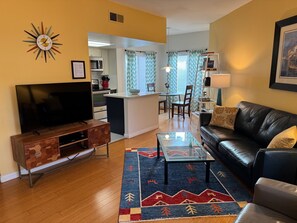 Living area towards kitchen.  50" flat screen.