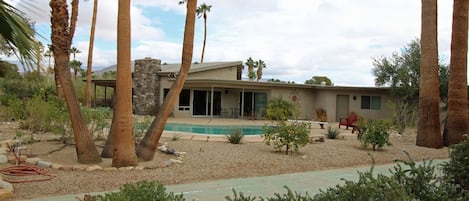 Looking at the rear of our house with pool and shuffleboard court