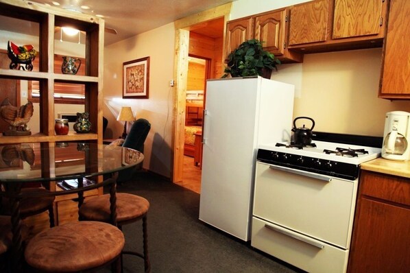 Kitchen area in foreground; sitting area in background