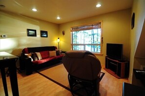 Living room with large bay window overlooking Auke Nu Cove and Auke Bay.