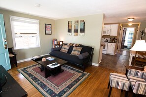 Overview of apt layout: living room, kitchen, hallway, bedroom to left, bathroom