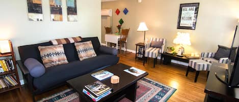 Living room with comfy full-sized futon and reading nook