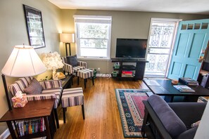 Reading nook in living room with doors and windows open to let in the fresh air