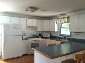 Well equipped kitchen including gas stove, microwave, refrigerator