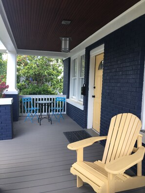 Front porch with Adirondacks and bistro table 