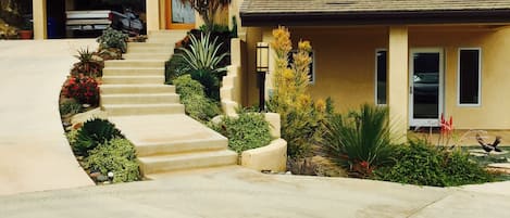 Driveway leading to entrance. The walkways are adorned with many succulents.