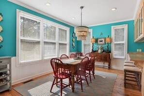 Light filled spacious dining room with views to the pool