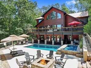 Newly renovated back yard with seasonally heated pool, 12ft hot tub, fire pit, and pool-side lounge & dining area. 