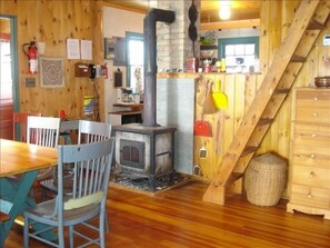 Kitchen, Dining area, Pot Belly Stove, and Stairs to Loft Sleeping Area