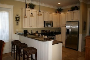 Gourmet kitchen with granite countertops and stainless steel appliances.