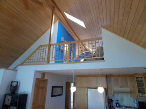 View from the great room fireplace up to the loft.