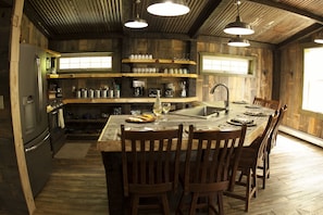 Kitchen - open shelving.  stove, refrig, micro & dish washer.  Farm house sink.