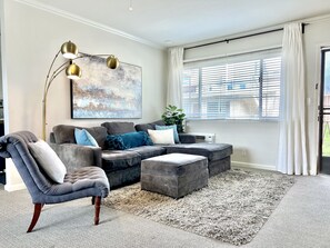 Spacious living room with a super comfy sofa and smart TV