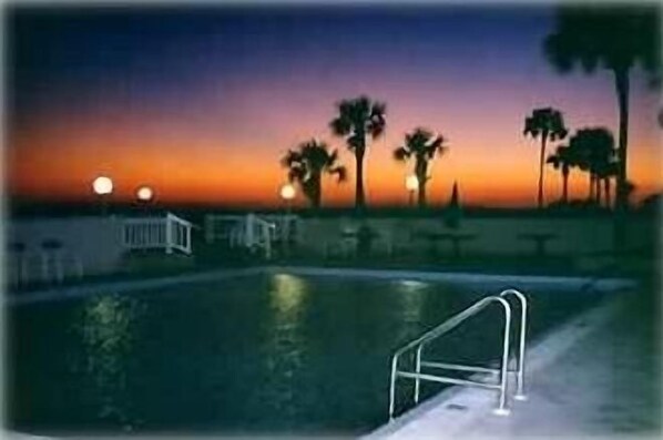Pool with beautiful sunset from outside patio