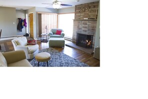 Living room with view of the front door and fireplace