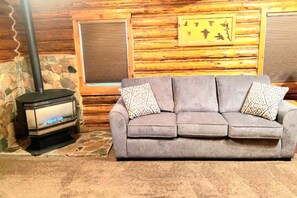The comfy & cozy living room features a gas fireplace & of space for everyone.