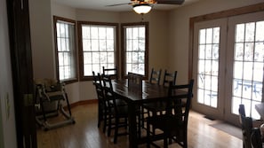 Sunny kitchen table with seating for 8, high chair and 3 seats at counter.