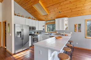 Large, clean kitchen with modern appliances and lots of counter seating