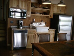 The full kitchen is completed with a grill on the patio.