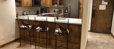 Kitchen area with bar stools